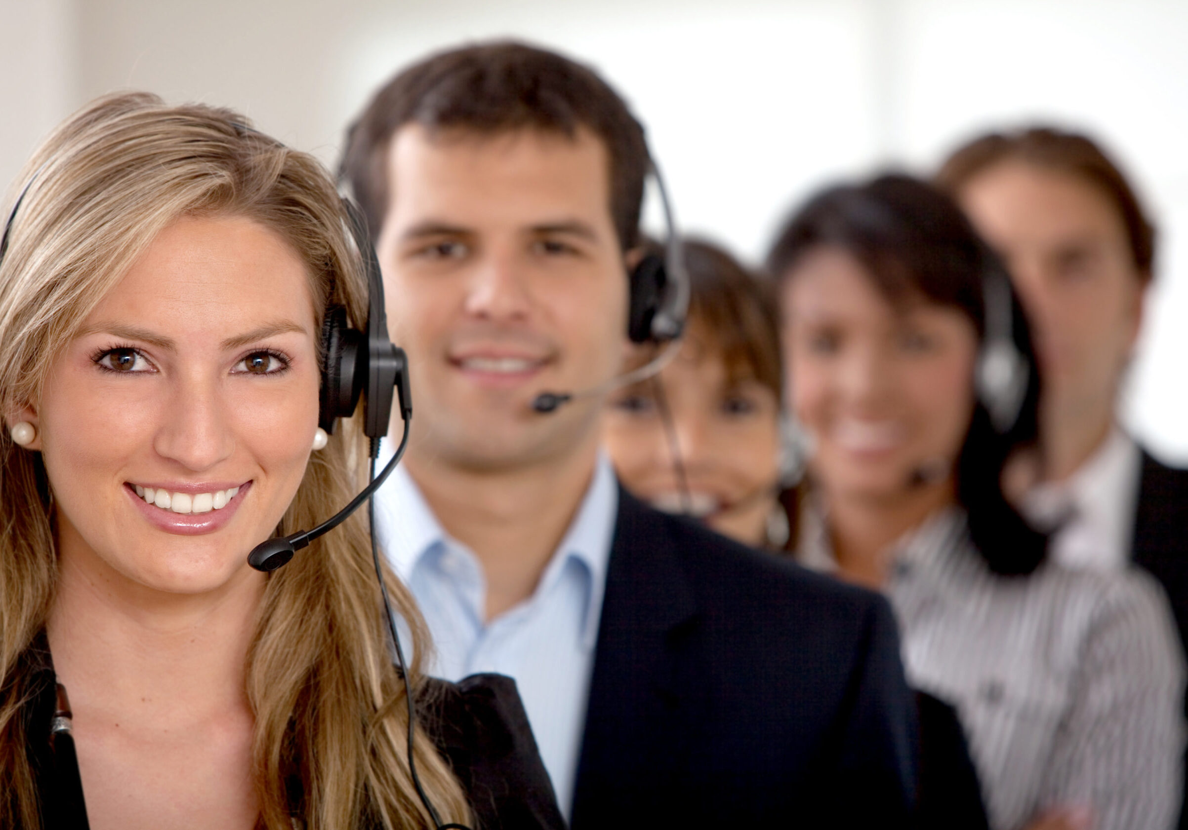 business customer support team in an office with headsets